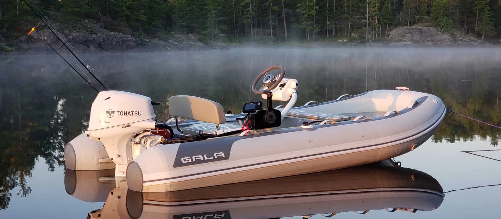 Gala Atlantis Aquahelm tender moored on a calm lake