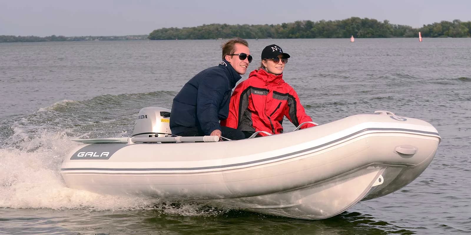 Gala Atlantis Lite tender carrying two passengers underway on a lake