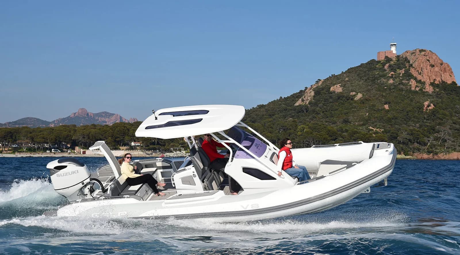 Gala Viking V8 underway near a rocky coastline